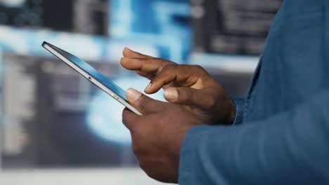 young professional engineer focused on coding with tablet at an innovation hub