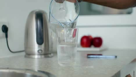 pouring water into a glass