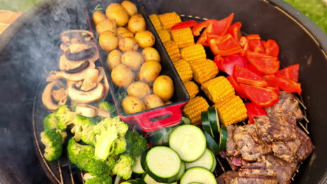 Cooking potatoes, peppers, mushrooms, corn, broccoli, and squash on an outdoor grill