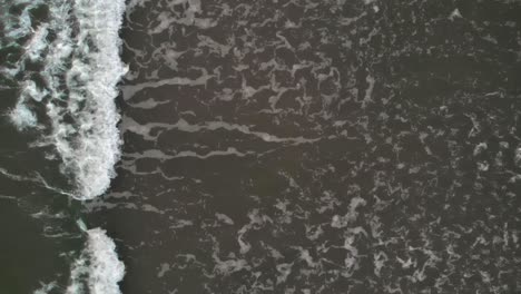aerial top shot of waves on baltic sea in slow motion
