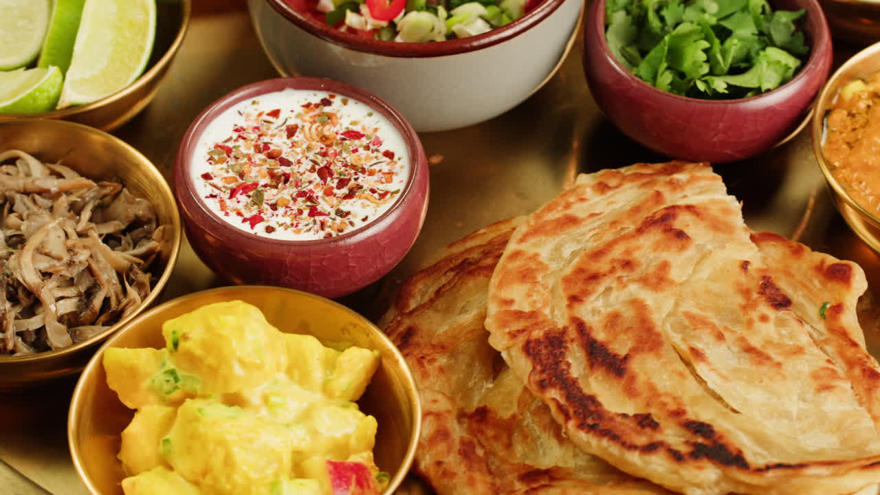 Close-up view of a delicious spicy curry served in a colorful bowl with a spoon, ready for a tasty meal.