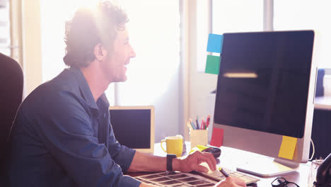 Male-graphic-designer-working-on-computer-monitor