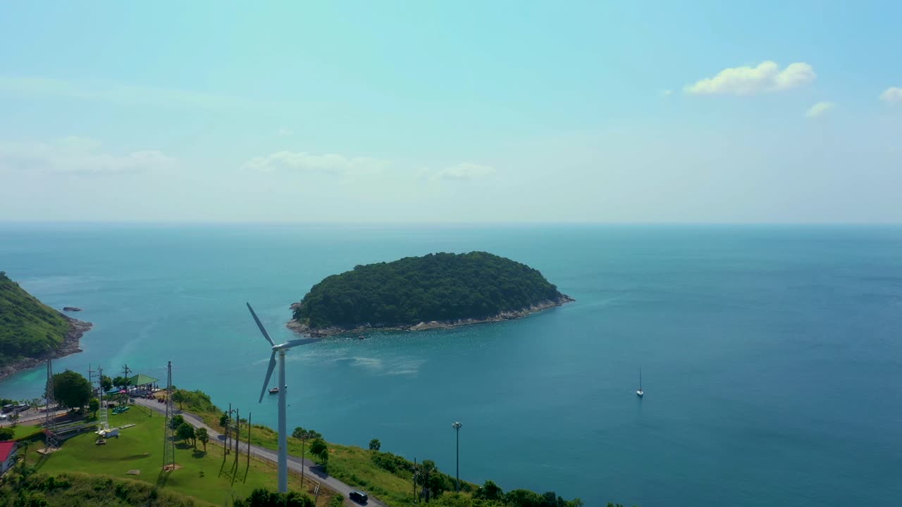 Aerial view of a wind turbine at Patong beach with blue turquois. Phuket