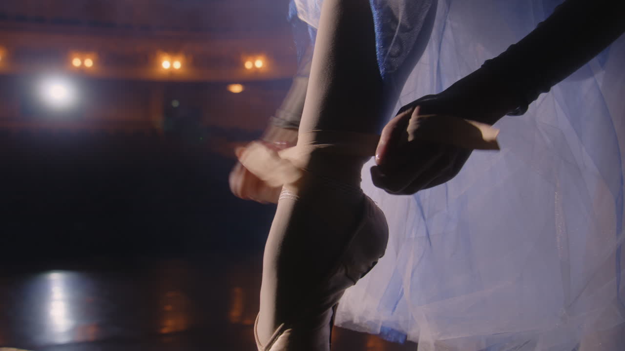 Ballet Dancer Adjusting Pointe Shoes