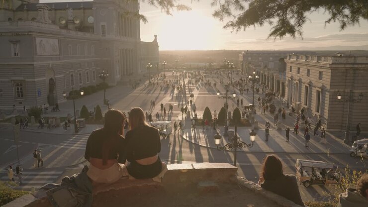 People at the Royal Palace of Madrid during Sunset
