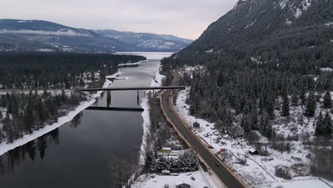 majestic river crossing: sunset on the thompson river in british columbia, as highway 1 span across on a grand bridge, drone view