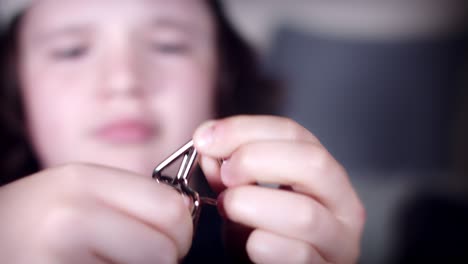 4k close-up boy face solving steel 3d puzzle or riddle