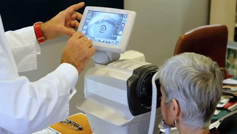 Optometrist-examining-patient-eyes-with-autorefractors-4k