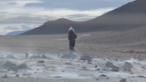 tourist explorer amidst iceland's volcanic fields