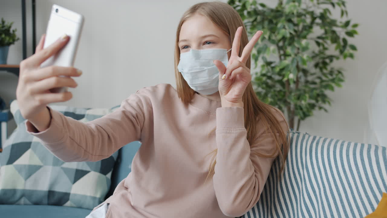 Teenage Girl Taking a Selfie While Wearing a Mask