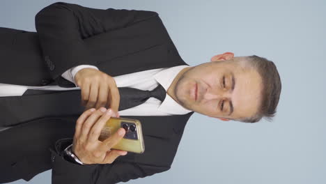 Vertical-video-of-Businessman-shopping-on-the-phone-with-a-credit-card.