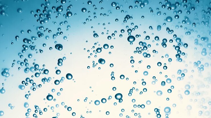 Many water bubbles in blue water close up, abstract water wave with bubbles in slow motion.