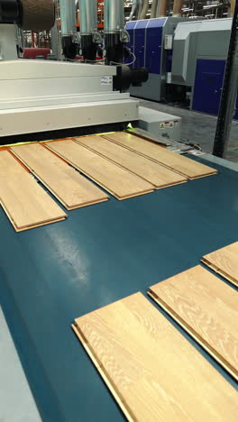 manufacturing lines for the manufacture of parquet full of value are operating in the woodworking plant. parquet production technology vertical video