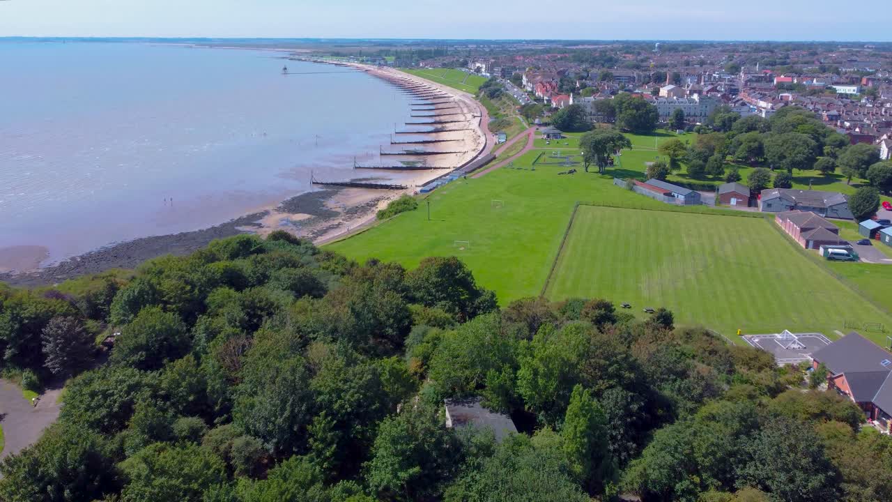 Aerial View of a Coastal Town with Beach and Park