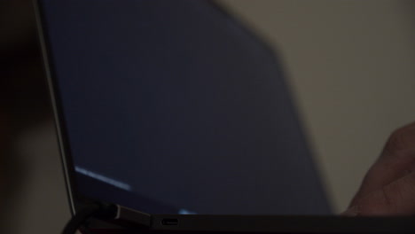 close up of a male hand using a search engine on a laptop with blurry christmas results on the monitor