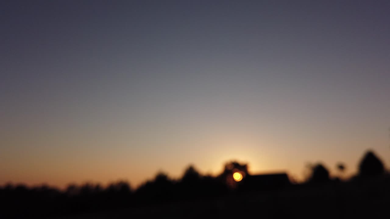Defocused hyperlapse of sun rising, blue, golden hour, clear purple sky