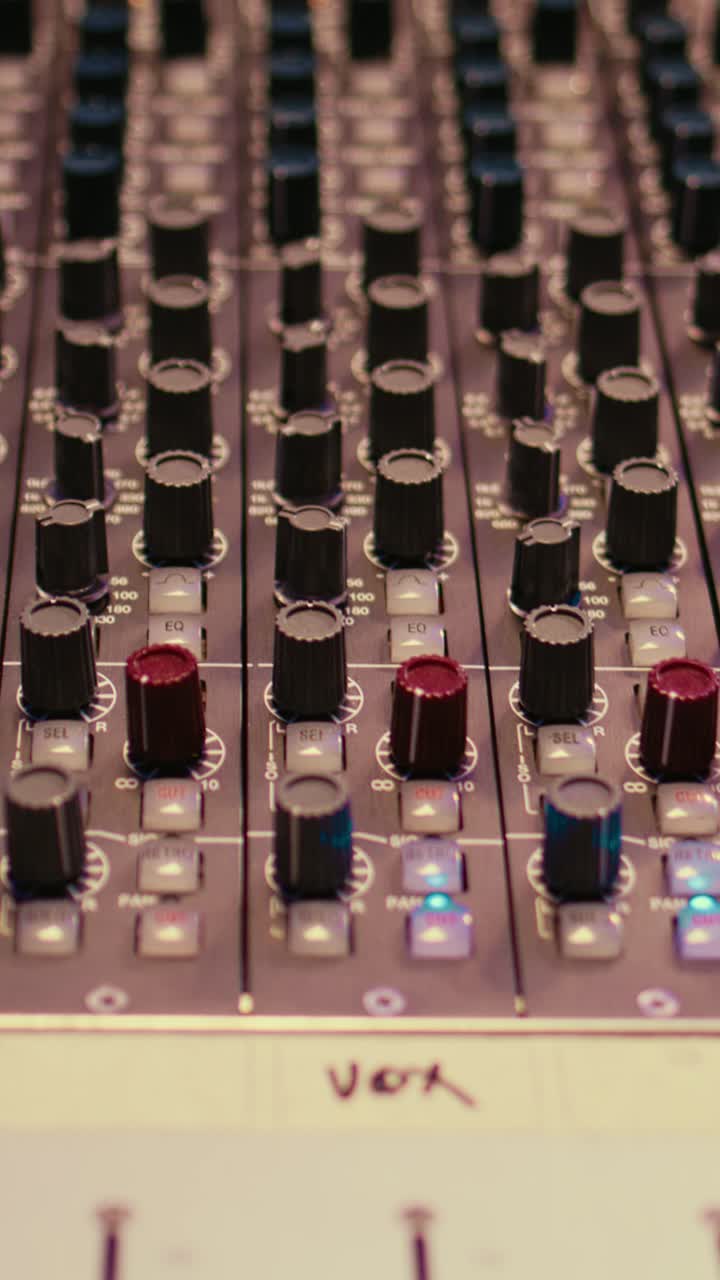 Nærbillede, lodret panorering af et professionelt audio mixerpult