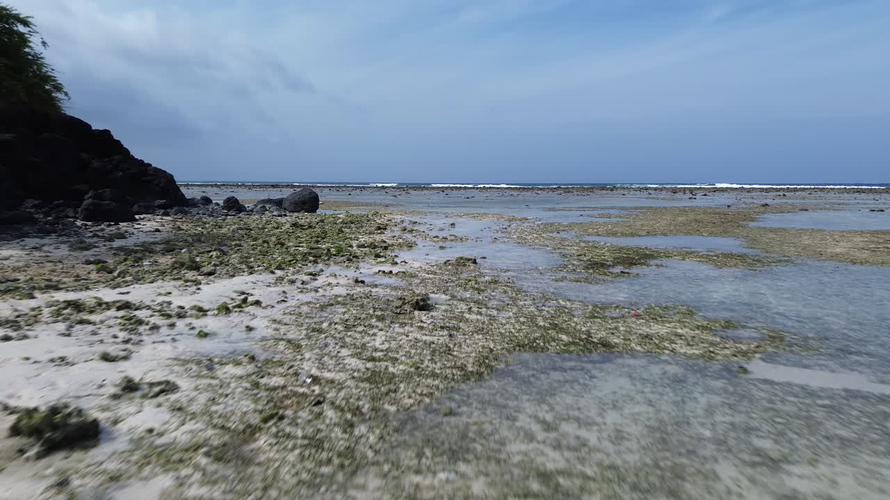 Aerial drone view of Gili Trawangan stunning beach. Crystal-clear waters on white sand beach on vibrant island scenery, famous travel destination with stunning nature landscape with no people.