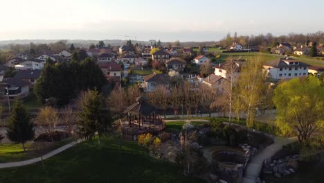 Drohnenaufnahme-Eines-Kleinen-Parks-Mit-Einem-Holzunterstand-über-Einem-Wasserfall