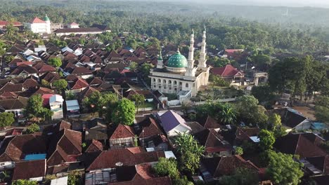 AERIAL-4K-Upward-Pan-Over-Large-Mosque-with-Mount-Rinjani-In-Background