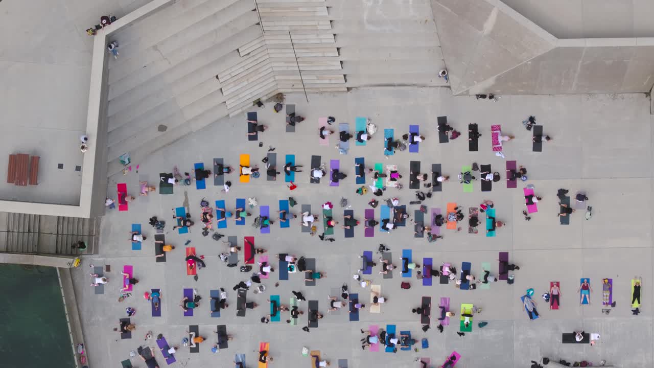 4K cinematic drone footage of a large outdoor yoga class in Dún Laoghaire, Ireland_34