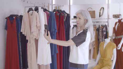 Blonde-woman-talking-on-cell-in-fashion-store