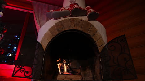 Burning fire in the fireplace. Low angle view of the fireplace with medium size flames. Flame burns in the fireplace at night and making a comfort