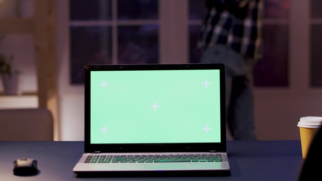 Laptop With Green Screen Display on Office Desk