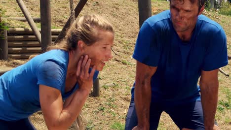 Man-and-woman-working-out-at-bootcamp