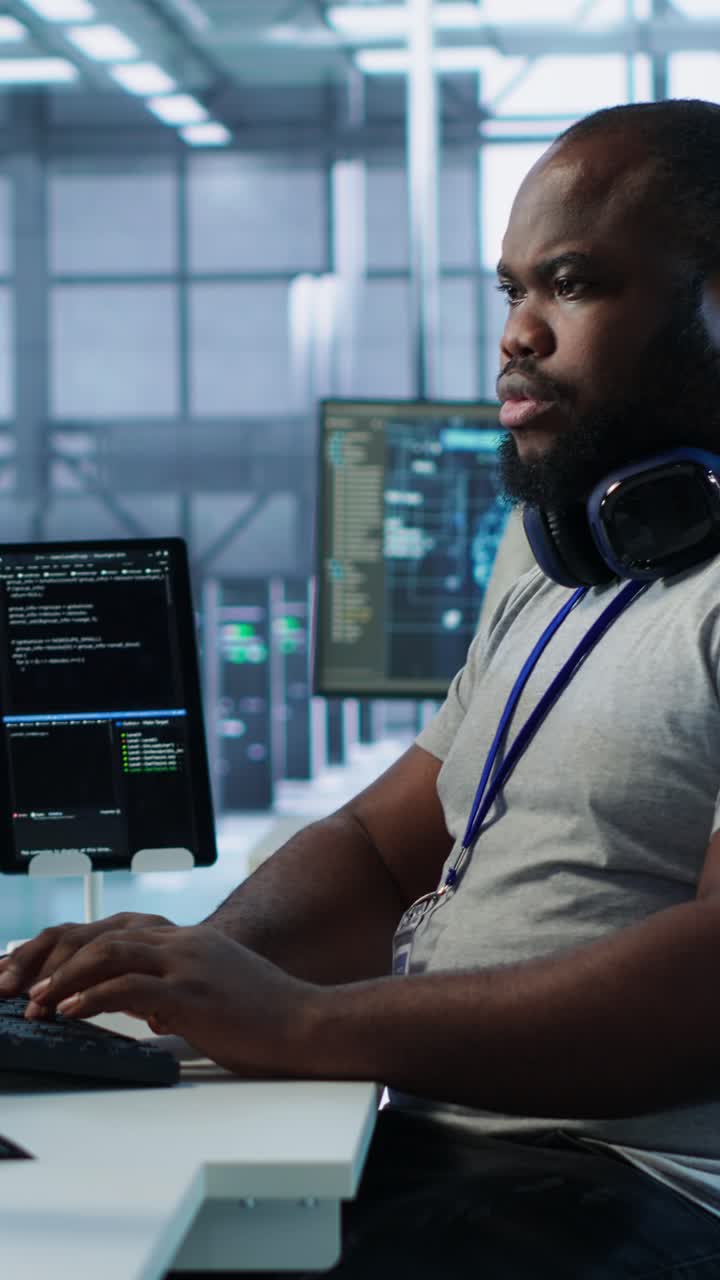 African American Programmer Working on Code in Data Center Office