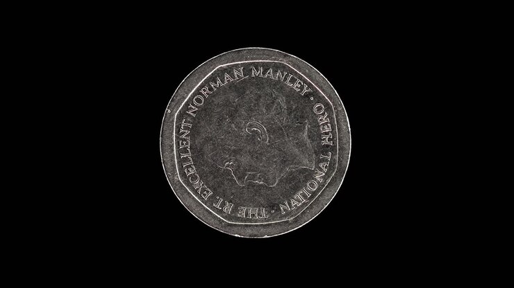 Rovescio della moneta da 5 dollari giamaicani del 1996 con il ritratto di Norman Manley che ruota su sfondo nero