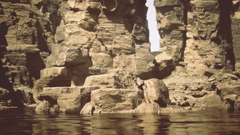 rugged cliffs rise above reflective waters in a serene wilderness landscape
