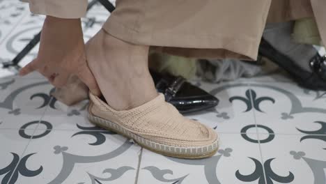 woman trying on shoes in a fitting room