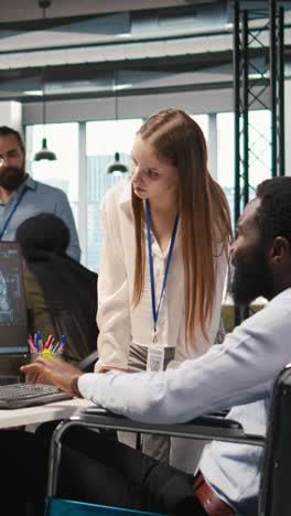 vertical video junior dev and coworker in wheelchair developing ai software applications