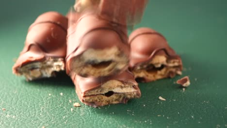 broken chocolate bars on green surface