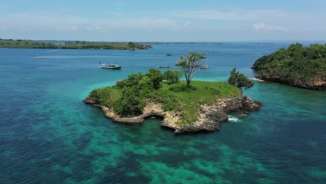 steady drone shot of a beautiful islet outside of lombok, indonesia during a sunny summer day