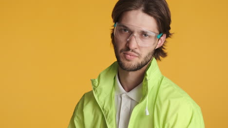 caucasian man in front of camera on yellow background.