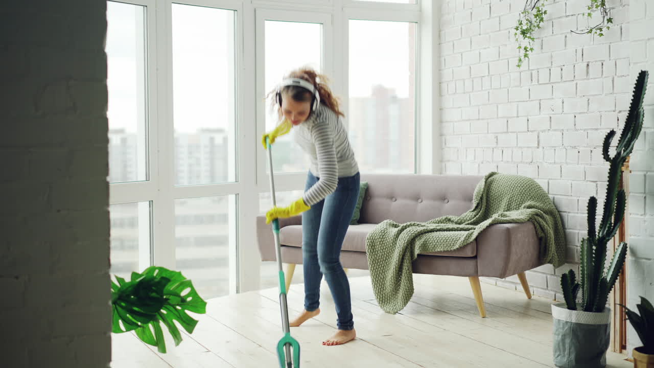 Woman Cleaning Her Home With Energy