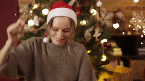 happy girt wearing red santa claus hat, holding bengal shining sparkler light