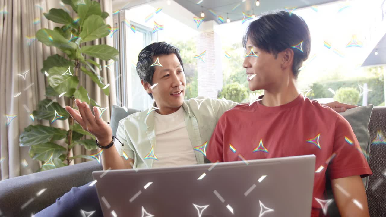 Father guiding son with laptop prompt for learning, sitting on sofa, sparkles drifting over laptop