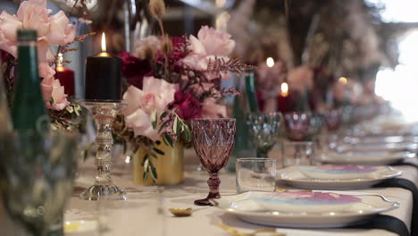 panning showing the glassware and decorations used on a table at a wedding reception