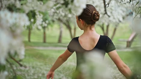 young ballerina in a spring garden