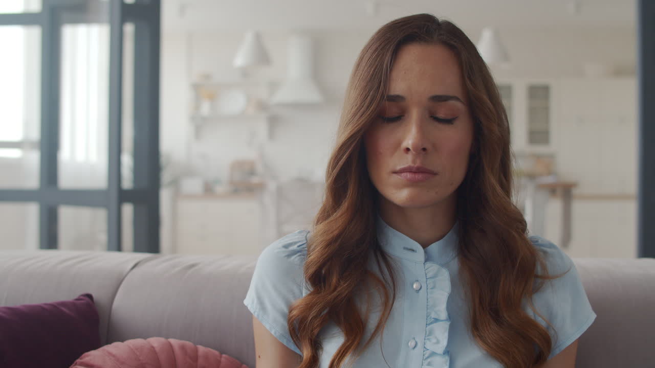 Sad business woman calming down at home office in slow motion.