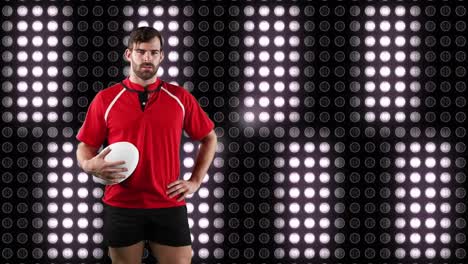 jugador de rugby profesional sosteniendo una pelota frente a una pantalla digital