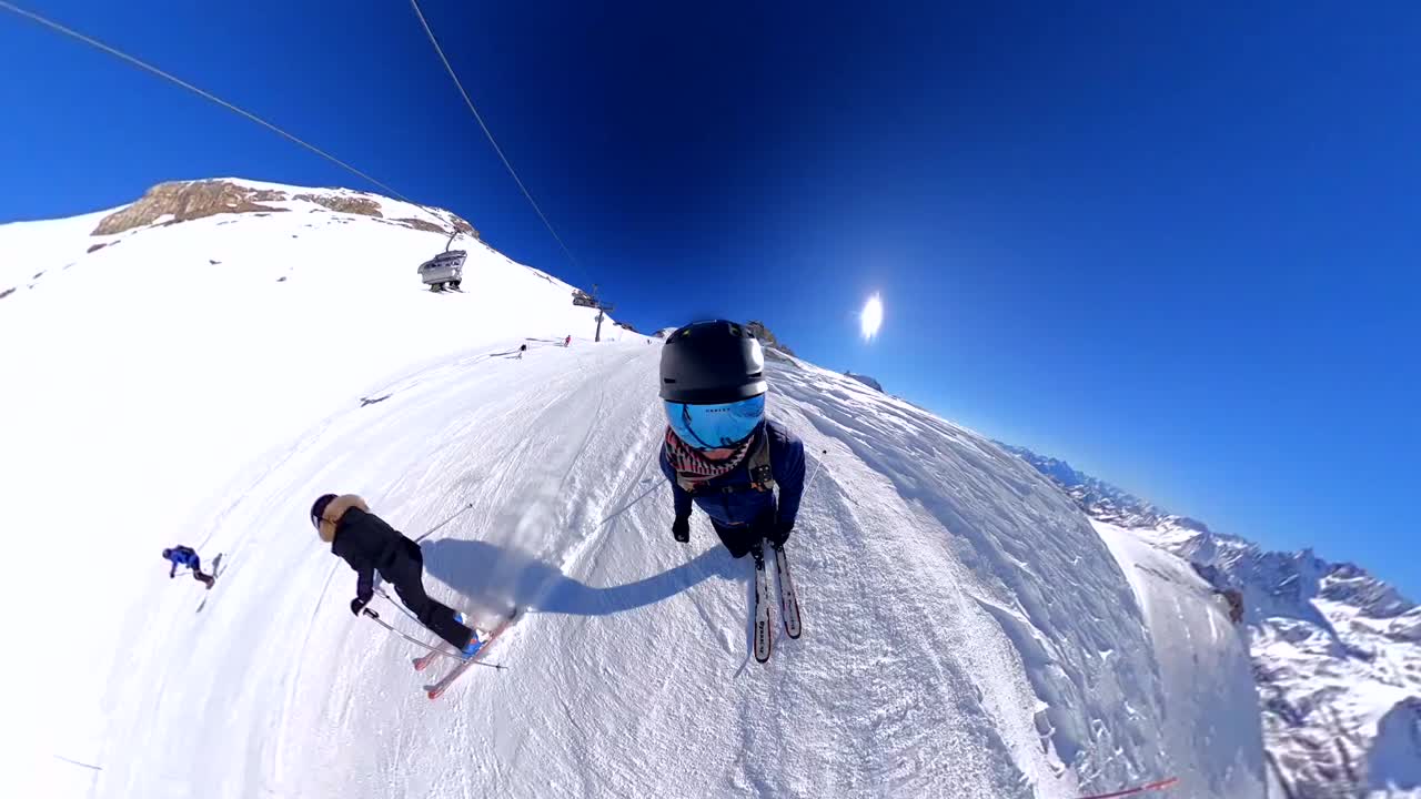 Front-face view of technical skier gracefully turning down Italian slope