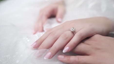 a 4k close up shot of a brides hand wearing a sparkly wedding ring