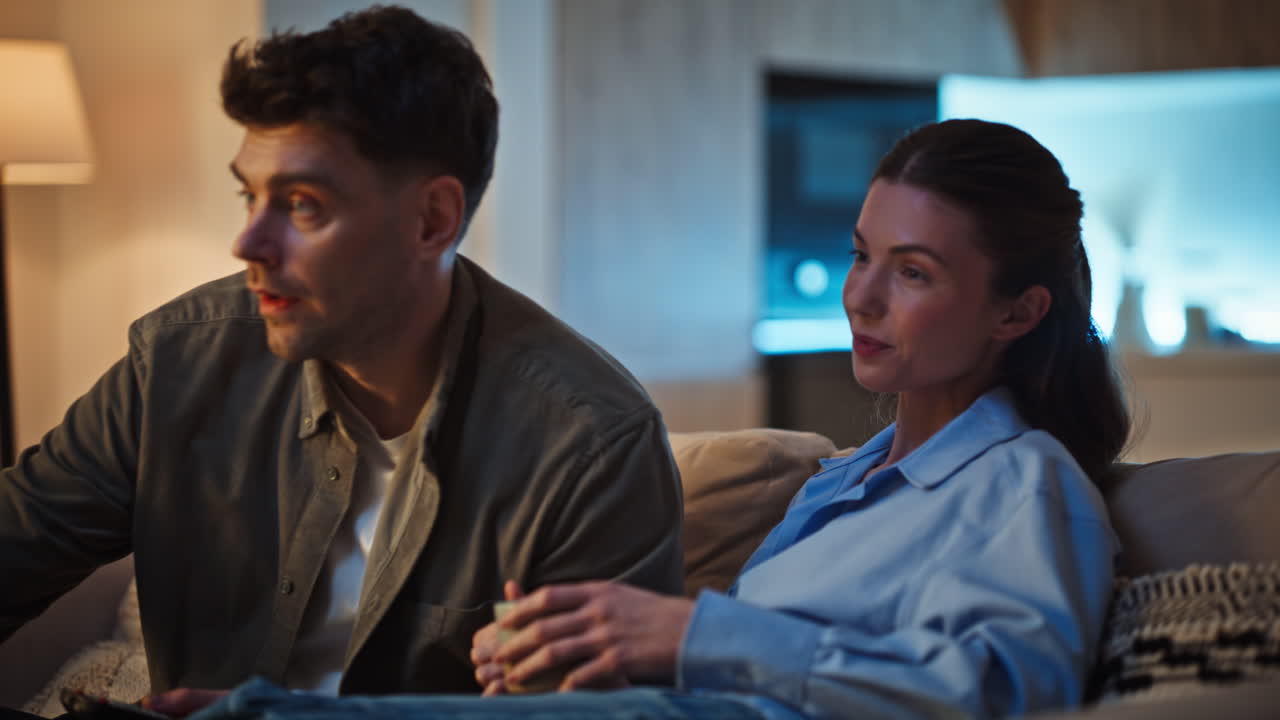 Happy lovers discussing TV show love bonding at comfortable home sofa closeup