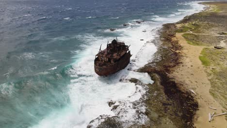 Aerial-orbit-over-a-shipwreck-standing-on-the-shore-of-the-Klein-Curacao-island-in-the-Caribbean