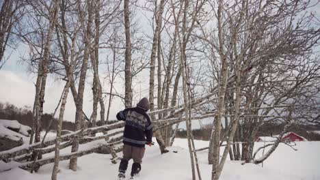 man cutting tree branches with loppers scissors