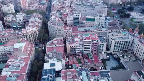 Barcelona's-cityscape-at-dusk,-showcasing-the-dense-urban-layout,-aerial-view